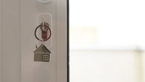 Key in the door lock with space for copy, concept of real estate and buying h Stock Footage 205932327