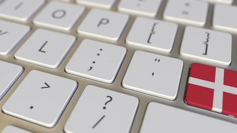 Key with flag of Denmark on the computer keyboard switches to key with flag of Stock Footage 109215022