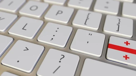 Key with flag of Georgia on the computer keyboard switches to key with flag of Stock Footage 109284219