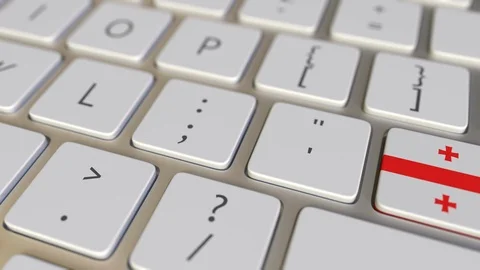 Key with flag of Georgia on the computer keyboard switches to key with flag of Stock Footage 109454367