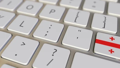 Key with flag of Georgia on the computer keyboard switches to key with flag of Stock Footage 109658571