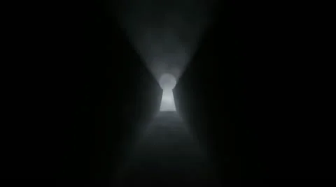 A key hole with bright light coming in from outside.Zoom in Stock Footage