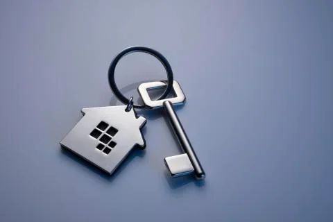 Key with house shaped key chain isolated on grey background Stock Photos