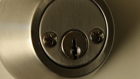 Key Inserted into Deadbolt Door Lock and Turned to Right Residential Medium C Stock Footage 114033643