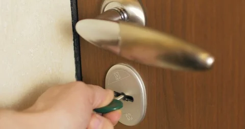 Key is inserted into door keyhole of the house and open and close the door lock. Stock Footage 110714363