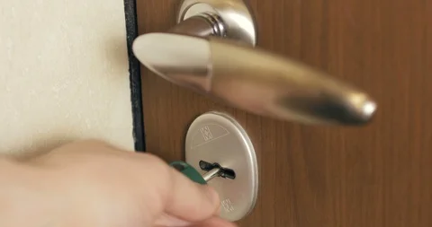 Key is inserted into door keyhole of the house and open and close the door lock. Stock Footage 110714391
