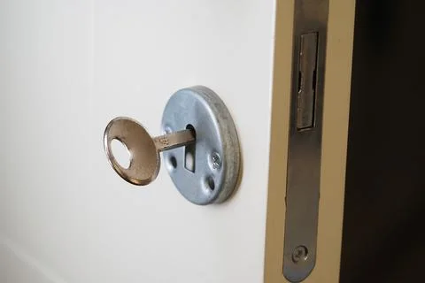 Key inserted in a door lock at a residential place Stock Photos