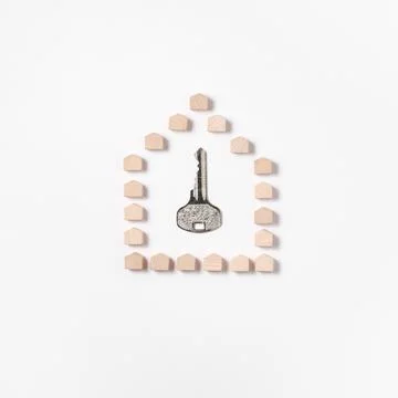 The key is inside the figurine house. Stock Photos