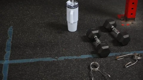 Key items for a good workout are dumbbells and hydration to boost fitness Stock Footage 314577514