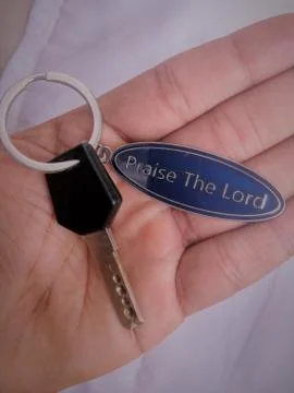 A key with a key chain in a hand. Stock Photos