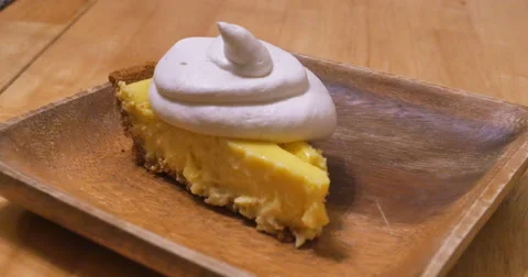 Key lime Pie with Wipe Cream on Wooden Plate, 4K Stock Footage 63419260