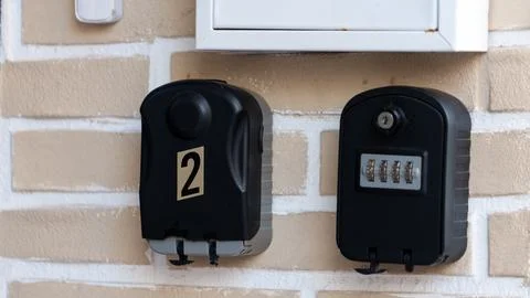 Key lock boxes with code mounted on wall secure access 写真素材