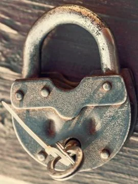 Key in lock grunge Stock Photos