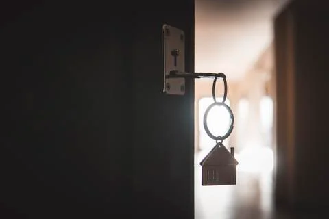 A key in a lock with house icon. process of opening the front door to the apa Foto stock