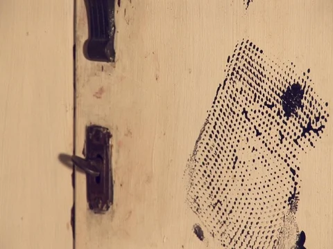 Key in a lock on an old wardrobe, with hand prints over it. Stock Footage 79907372
