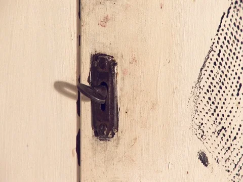 Key in a lock, shadow in the background moves slowly Stock Footage 79907093