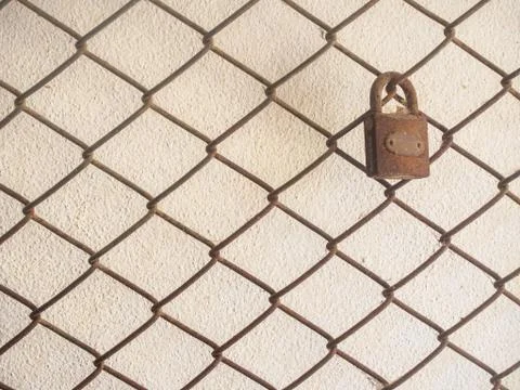 The key on netting grid on cement wall background Stock Photos