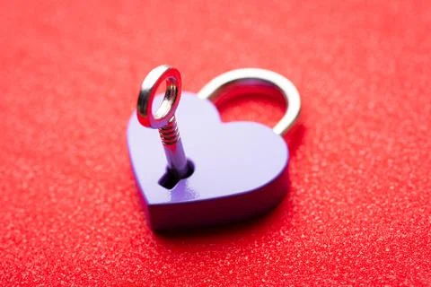Key opening lock in shape of a heart Stock Photos