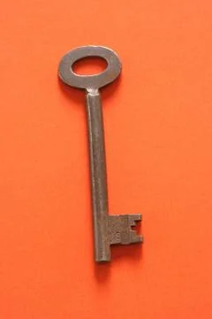 Key on an orange background Foto stock
