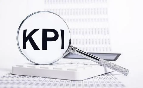 Key performance indicators. Magnifier with KPI letters, statistics documents and Stock Photos