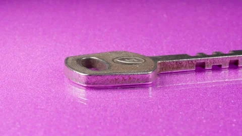 Key on a pink background close-up. Silver metal. Stock Footage 140474174