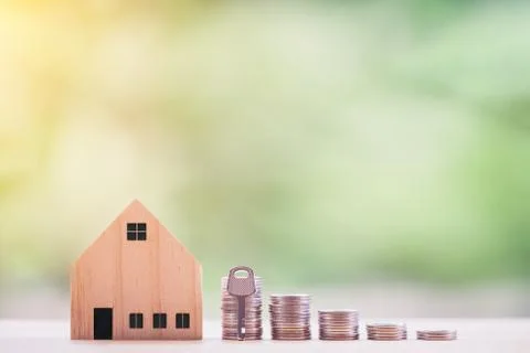 Key placed front of stack coins with model house. Model house with key house Stock Photos