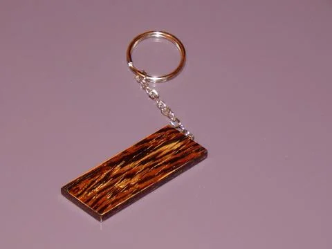 The key ring is made from precious Wenge wood. Handmade Stock Photos