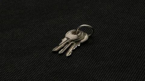 The key is silver with a black background. Stock Photos