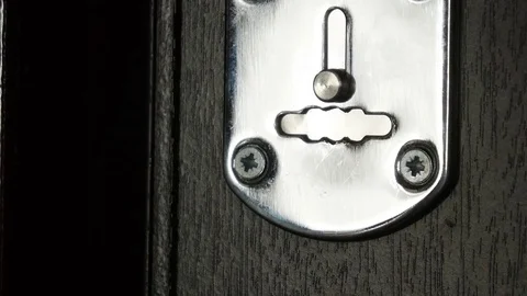 Key sliding into lock and locking\ unlocking door. Close-up. Stock Footage 70400425