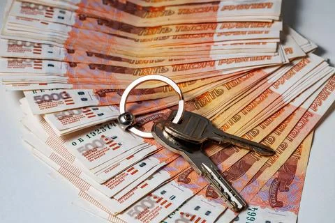 Key on stack of banknotes, many banknotes of five thousand Russian rubles as a Stock Photos