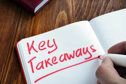 Key takeaways written by man in the note. Stock Photos