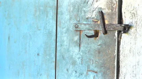 Key unlocking an old rustic door latch. Stock-Footage 55033443