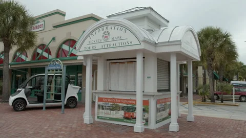 Key West information ticket kiosk booth trolley tours 6k video Stock Footage 131906776