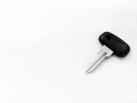 The key is on a white background. A key with a plastic handle on a white back Photos