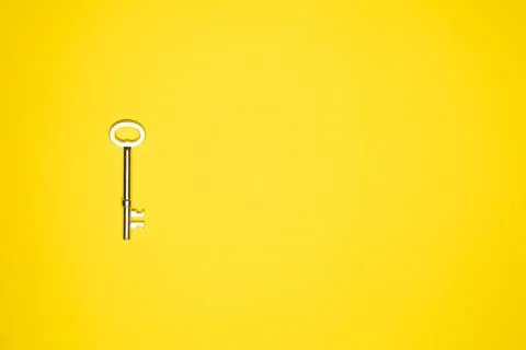 Key on yellow background. Minimal creative style Stock Photos
