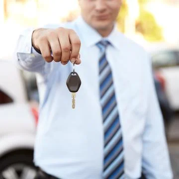The key to your new ride. Cropped image a mans hand holding a car key. Stock Photos