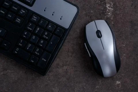 Keyboard and computer mouse on dark gray background 스톡 사진