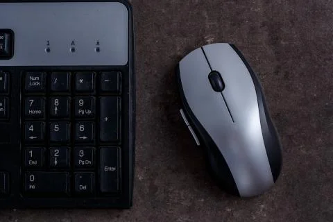 Keyboard and computer mouse on dark gray background Stock Photos