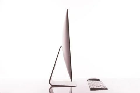 Keyboard and computer screen on a white table with reflection on white backgr Stock Photos