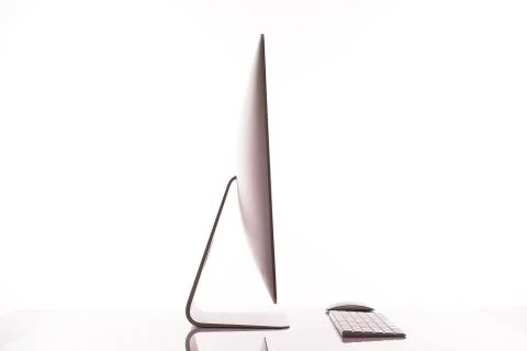 Keyboard and computer screen on a white table with reflection on white backgr Stock Photos