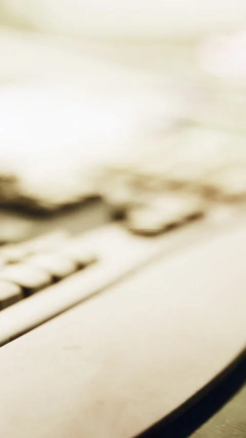 Keyboard and desk close up in office setting during daylight hours Stock Footage 341040388