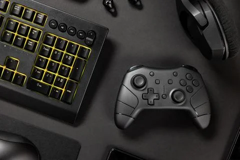 Keyboard and game controller amidst various wireless devices Stock Photos