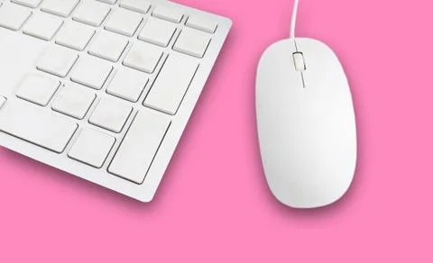 Keyboard and mouse on a pink background Stock Photos