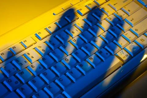 Keyboard and shadow. data theft. Stock Photos