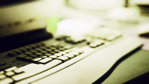 Keyboard and workspace setup highlighting technology in a dimly lit environment Stock Footage 330059594