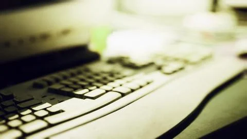 Keyboard and workspace setup highlighting technology in a dimly lit environme イラスト素材