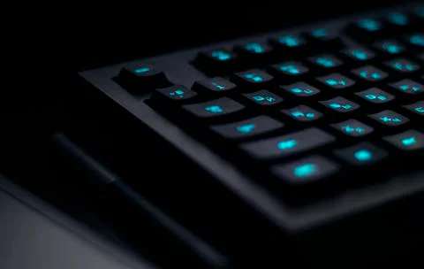 Keyboard with blue backlight on work table. button light Stock Photos