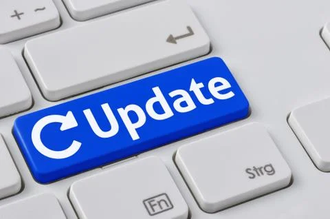 A keyboard with a blue button - Update Stock Photos