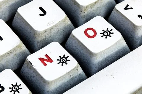 Keyboard button with NO written in red color. Close up macro photo of worn .. Stock Photos