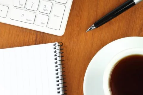 Keyboard, coffee, notepad and pen Stock Photos